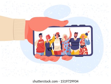 Male hand holding mobile phone with happy smiling men and women  displaying on screen. Friends posing for selfie, group of joyful people photographing themselves, embracing each other, waving hands.