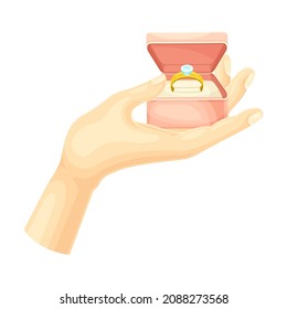 Male hand holding opened red box with golden ring with diamond vector illustration