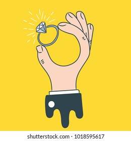 Male hand holding ring. 