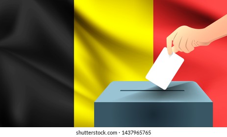 Male hand puts down a white sheet of paper with a mark as a symbol of a ballot paper against the background of the Belgium flag, Belgium the symbol of elections
