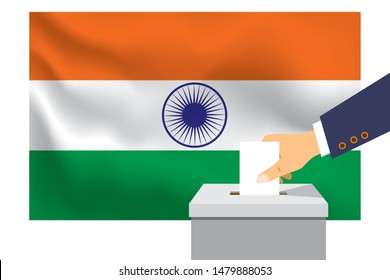 Male hand puts down a white sheet of paper with a mark as a symbol of a ballot paper against the background of the India flag. India the symbol of elections.
