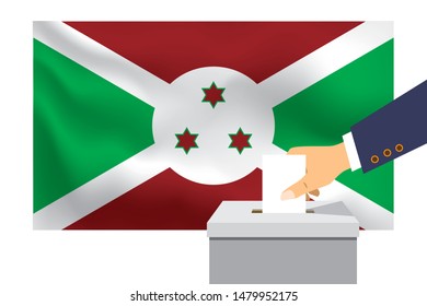 Male hand puts down a white sheet of paper with a mark as a symbol of a ballot paper against the background of the Burundi flag. Burundi the symbol of elections.