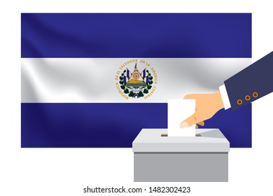 Male hand puts down a white sheet of paper with a mark as a symbol of a ballot paper against the background of the El Salvador flag. El Salvador the symbol of elections.