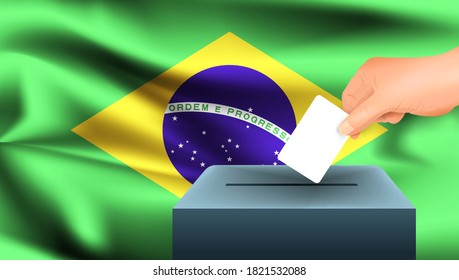 Male hand puts down a white sheet of paper with a mark as a symbol of a ballot paper against the background of the Brazil flag. Brazil the symbol of elections