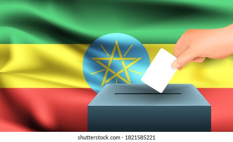 Male hand puts down a white sheet of paper with a mark as a symbol of a ballot paper against the background of the Ethiopia flag. Ethiopia the symbol of elections