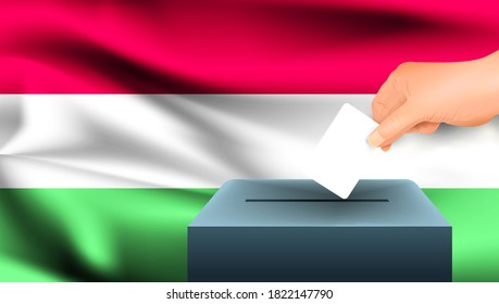 Mano masculina coloca una hoja blanca de papel con una marca como símbolo de una cédula de votación contra el fondo de la bandera de Hungría. Hungría el símbolo de las elecciones