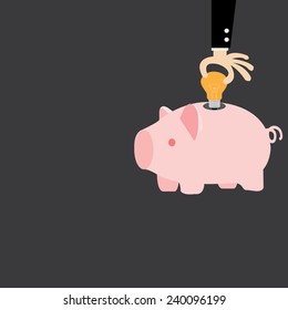 Male hand putting light bulb into a piggy bank, idea concept