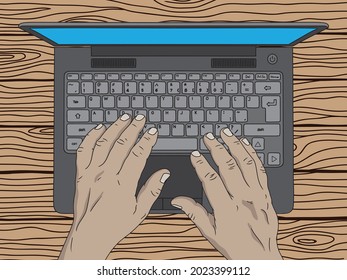 Male hands are typing text on the keyboard of an open laptop on a wooden table. Close-up top view.