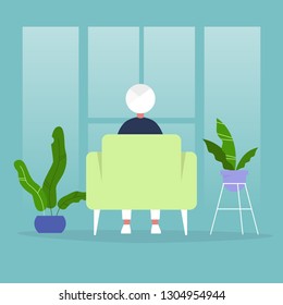 Male indian character sitting in a chair in front of the window. Back view. Interior concept. Flat editable vector illustration, clip art