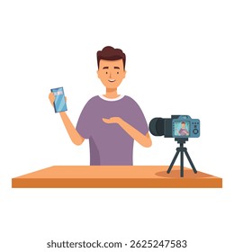 Influenciador masculino sentado na mesa de gravação de vídeo blog sobre novo smartphone usando câmera no tripé