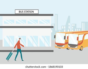 Male passenger wearing face mask and walking in bus station while carrying suitcase