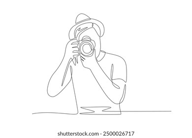 Male photographer in hat taking photo. World photography day concept one-line drawing