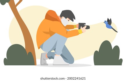 a male photographer with a mask holding a camera and taking pictures of birds. flat vector illustration with trees and plants background. for the theme of hobbies, photography and others