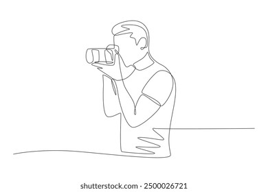 Male photographer taking photo facing sideways. World photography day concept one-line drawing