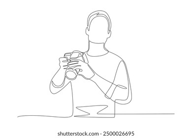 Male photographer. World photography day concept one-line drawing