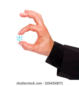 Male polygonal hand between two fingers holding a snowflake