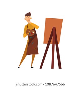 Male professional artist character in apron drawing on an easel with paints cartoon vector Illustration on a white background