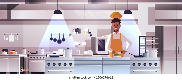 male professional chef cook chopping vegetables on carving board african american man in uniform preparing salad cooking food concept modern restaurant kitchen interior portrait horizontal