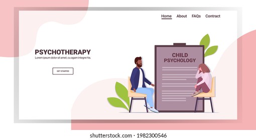 male psychotherapist consulting depressed girl patient during psychotherapy session child psychology