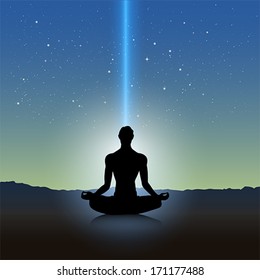 Male silhouette in meditation pose on landscape
