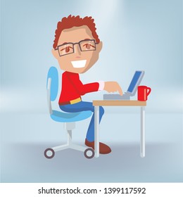Male sitting happy in the office at his work table and laptop