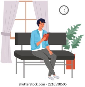 Male sitting on couch at home, chatting, communicating using tablet electronic device. Man talking by phone on sofa. Male sits with smartphone. Distance learning, freelance and internet entertainment