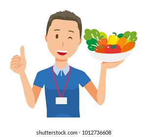 A male staff wearing nameplate has vegetables - upper body