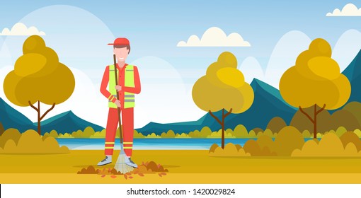 male street cleaner holding rake man sweeping lawn raking leaves cleaning service concept city park landscape background full length flat horizontal