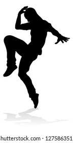 A male street dance hip hop dancer in silhouette