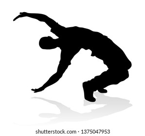 A male street dance hip hop dancer in silhouette