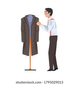 Male Tailor Adjusting Wool Coat on Mannequin, Clothing Designer Tailor Working at Atelier Vector Illustration