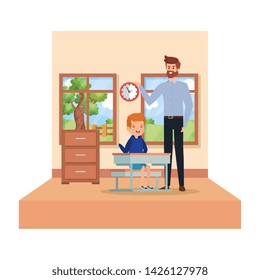 male teacher and boy seated in desk in the classroom