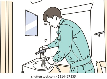 Male worker checking the shower head
