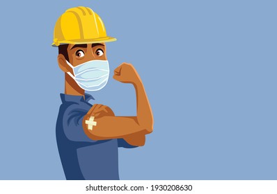 Male Worker Showing Vaccinated Arm. Man wearing hardhat just receiving anti coronavirus vaccine
