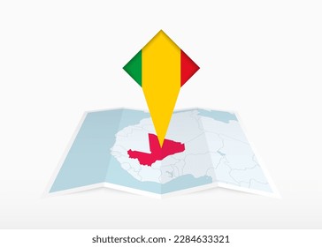 Mali is depicted on a folded paper map and pinned location marker with flag of Mali. Folded vector map.