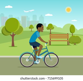 Man afro american riding a bicycle in the park. Vector flat illustration