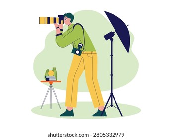 Man aims a large camera with a yellow lens, standing next to a studio softbox light.