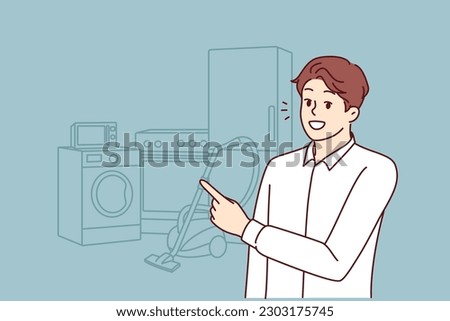 Man appliances salesman points finger at washing machine and vacuum cleaner with refrigerator. Smiling guy in shirt offers to visit home appliances store to create comfort in house