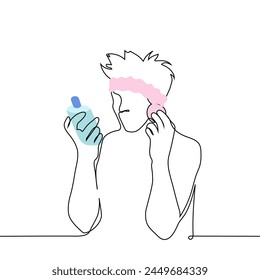 man applies cosmetic product to his face with a sponge while reading the text on the bottle of product - one line art vector. concept of modern man taking care of his facial skin. Handmade not AI