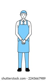 A man in apron bowing with folded hands.