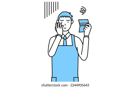 A man in an apron looking at his bankbook and feeling depressed.