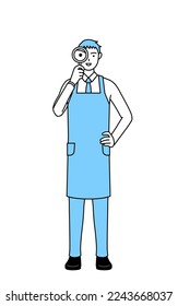 A man in an apron looking through magnifying glasses