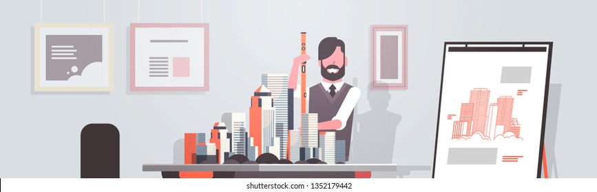 man architect holding level engineer working with new building city model for urban panning project concept house blueprint modern office studio interior horizontal portrait
