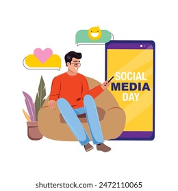 Man in armchair using his smartphone, large cellphone displays Social Media Day text