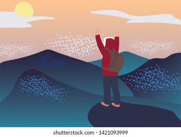 Man with backpack standing on top of mountain and looking on valley