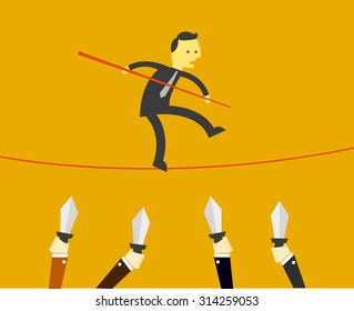 man balancing on rope with hands holding knives below
