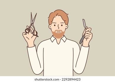 Man barber working in barbershop demonstrates blade and scissors for shaping beards and hairstyles to clients of salon. Hipster guy works in trendy barbershop invites to make new haircut 
