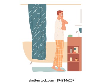 Man in the bathroom applies cream to his face