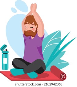 a man with a beard sitting on a yoga mat