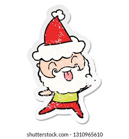 man with beard sticking out tongue wearing santa hat